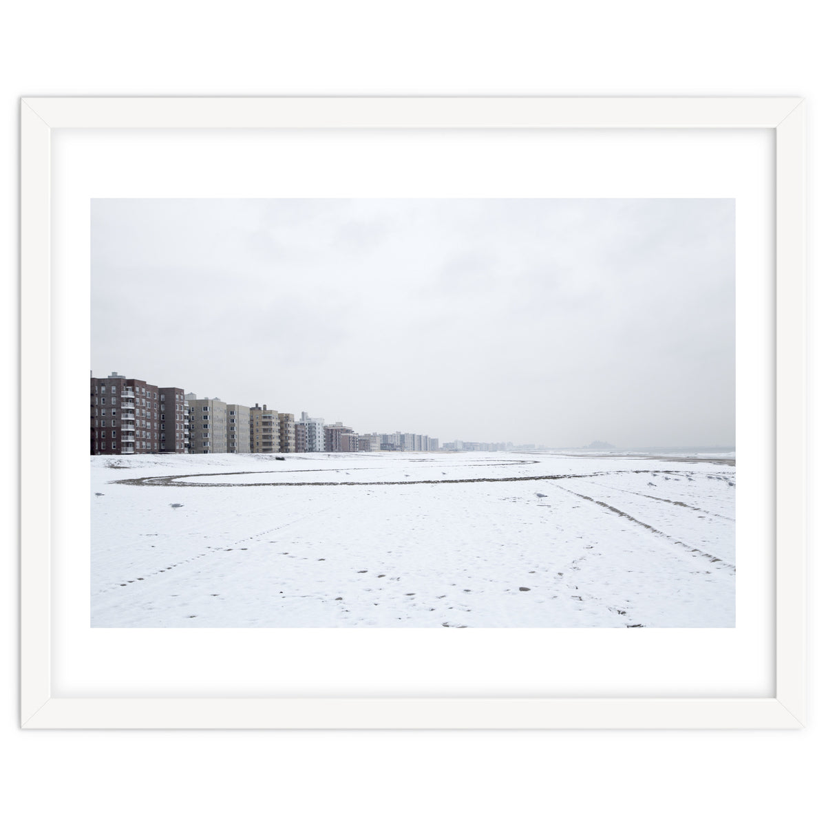 Traces of driving a car on a snowy coast