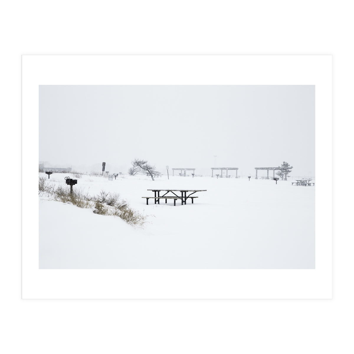 Tables and benches in a snow-covered park (Print Only)