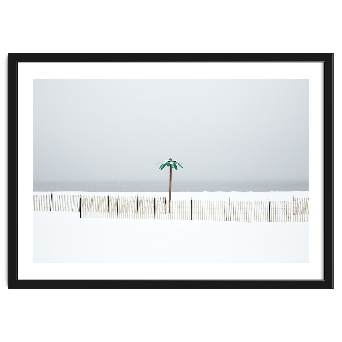 Fake palm tree in the winter snow beach