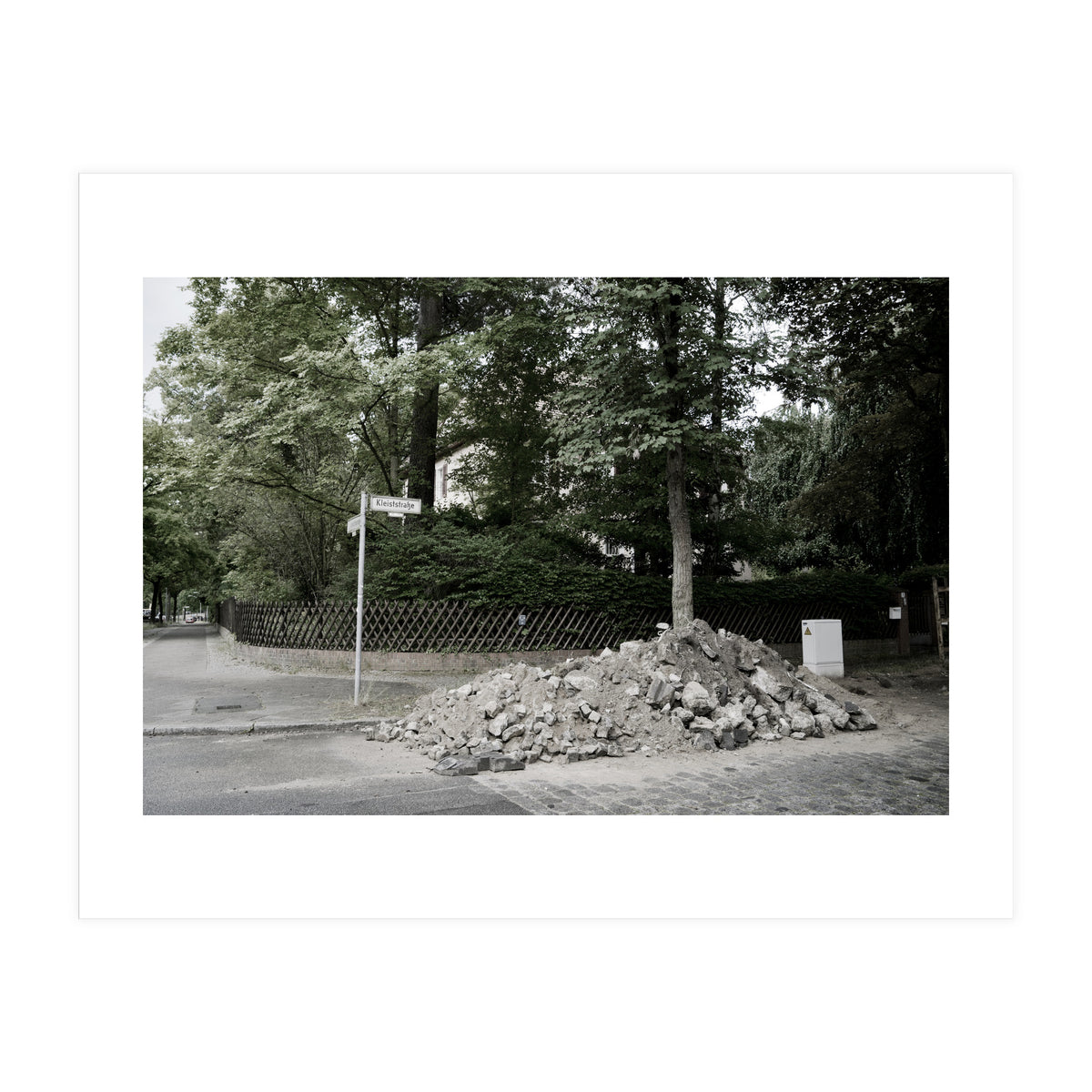 Piled-up rocks under construction on the street (Print Only)