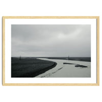 River passing through a black volcanic road - Iceland