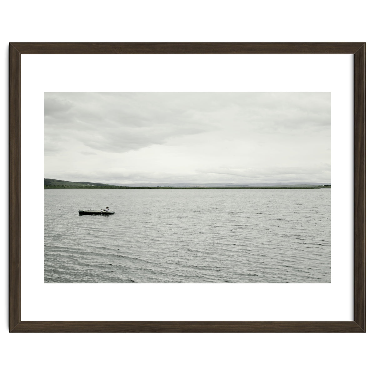A boy pedaling the Board on the Lake - Iceland
