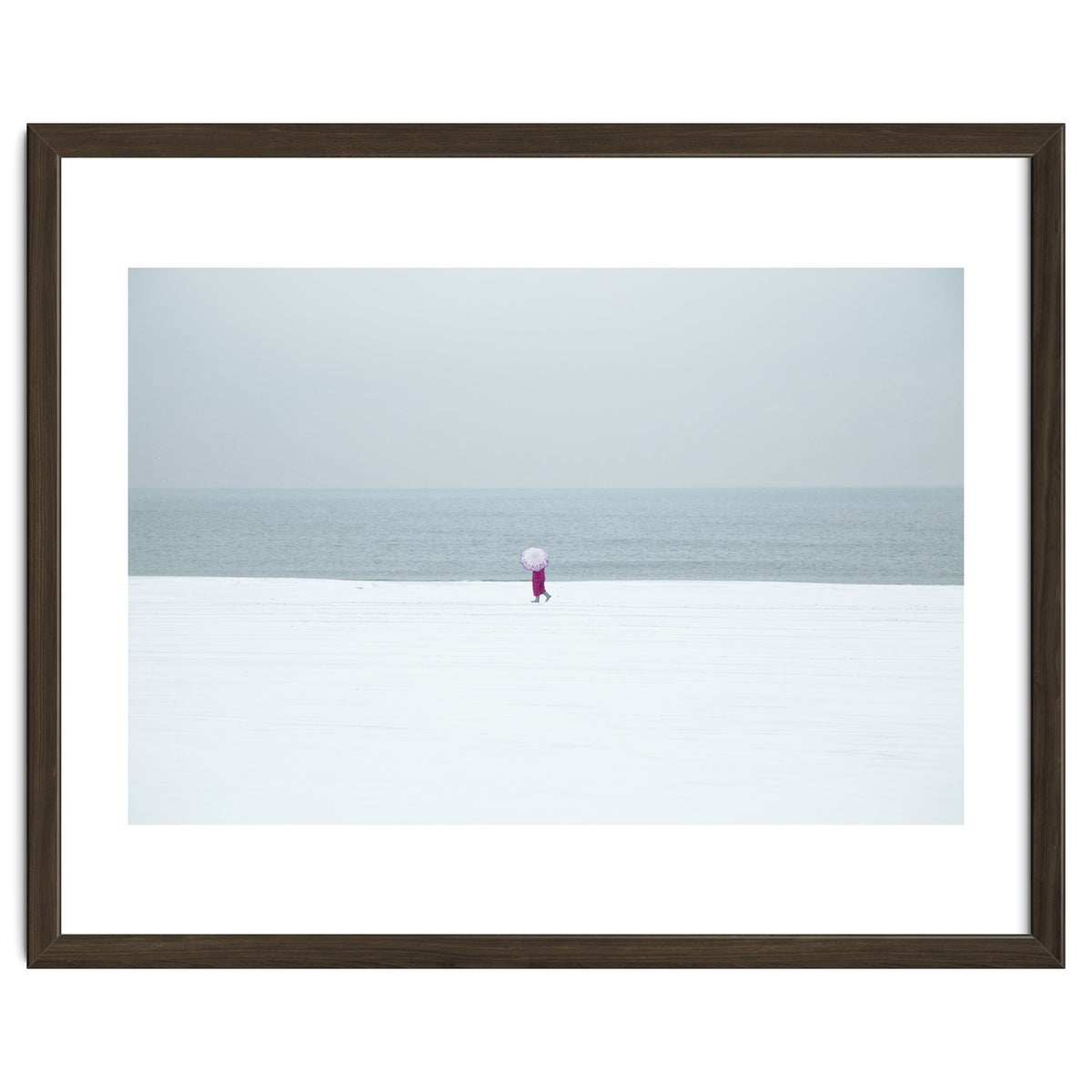 A walking woman in the winter snow beach
