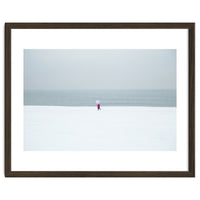 A walking woman in the winter snow beach