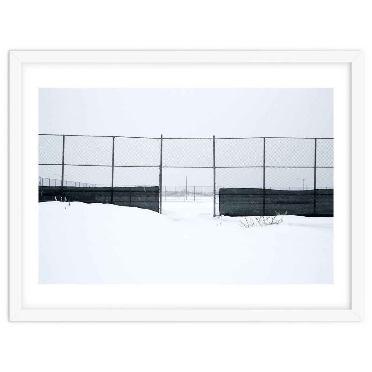 The entrance gate of the snow-covered baseball field