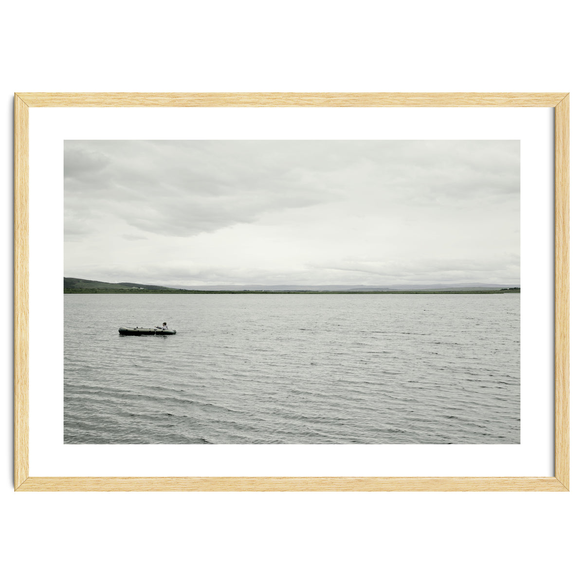 A boy pedaling the Board on the Lake - Iceland
