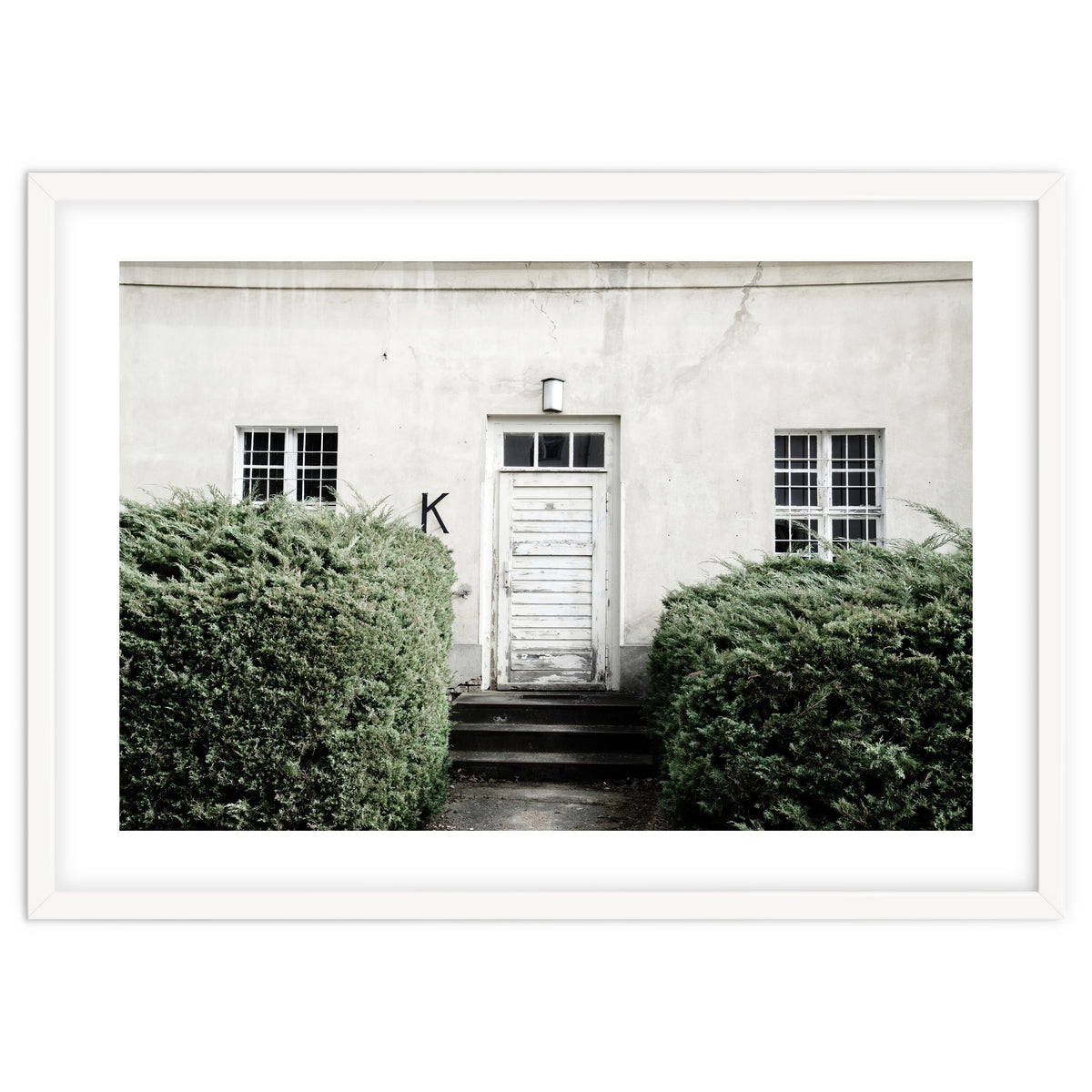 White door K between the green botanical gate