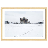 Footprints and house in winter snowscape thumbnail
