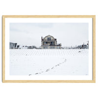 Footprints and house in winter snowscape