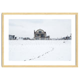 Footprints and house in winter snowscape thumbnail