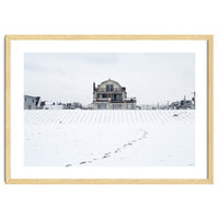 Footprints and house in winter snowscape