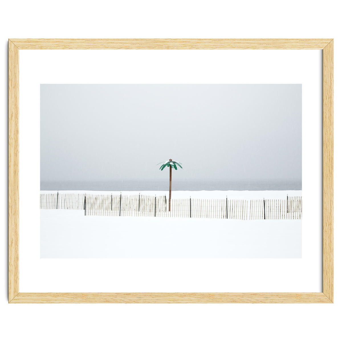 Fake palm tree in the winter snow beach