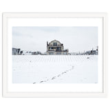 Footprints and house in winter snowscape thumbnail