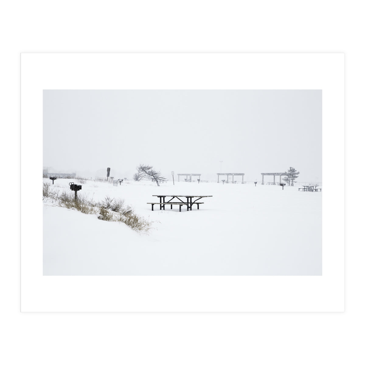 Tables and benches in a snow-covered park (Print Only)