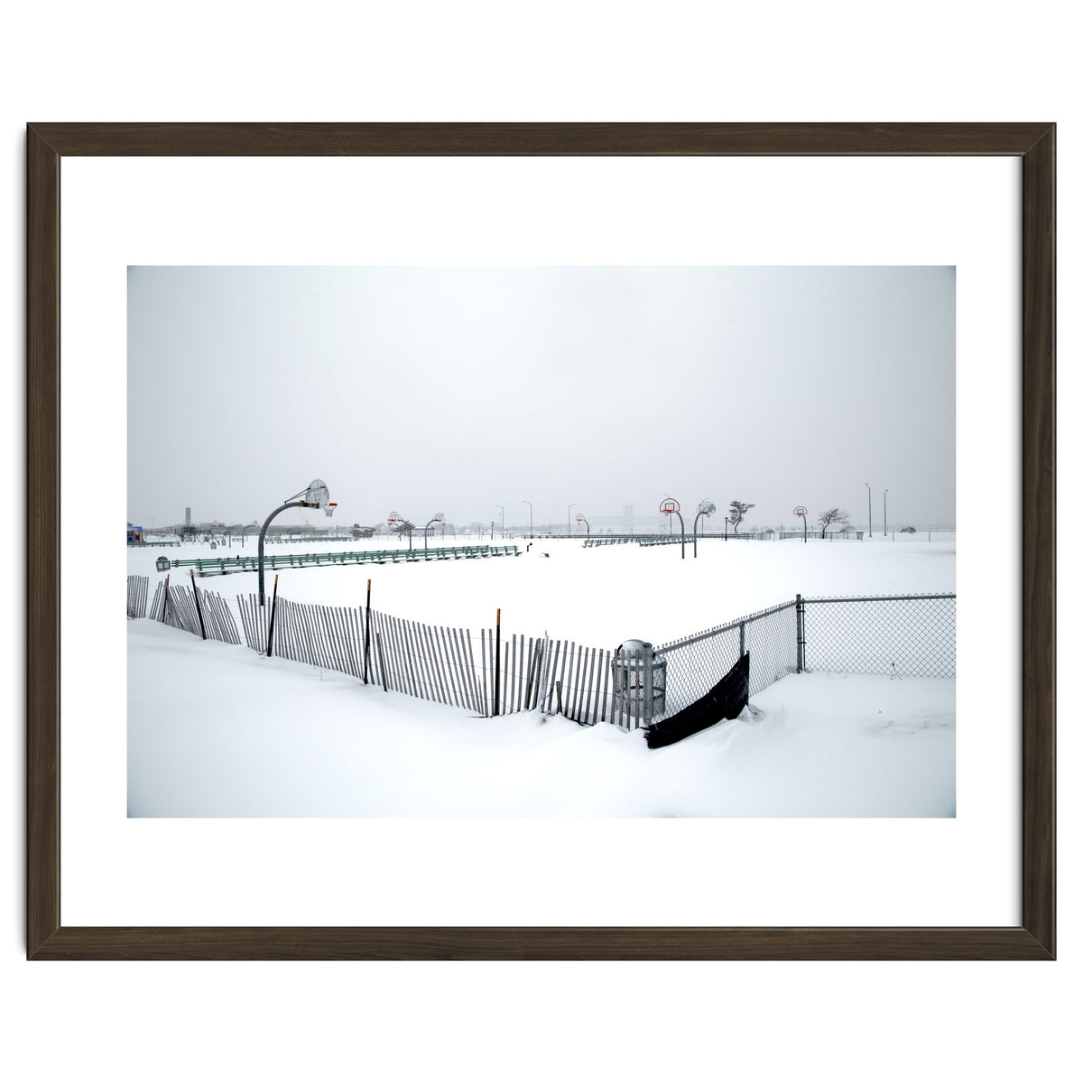 Snow-covered deserted basketball court in winter