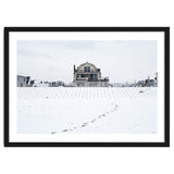 Footprints and house in winter snowscape thumbnail