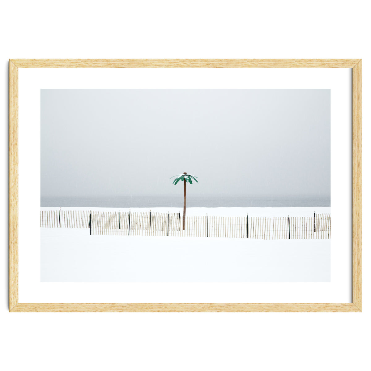 Fake palm tree in the winter snow beach