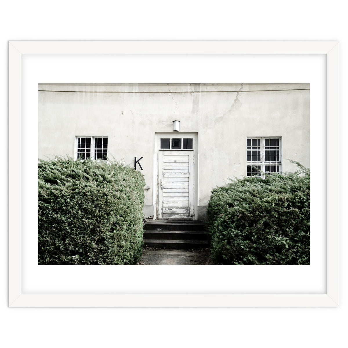 White door K between the green botanical gate