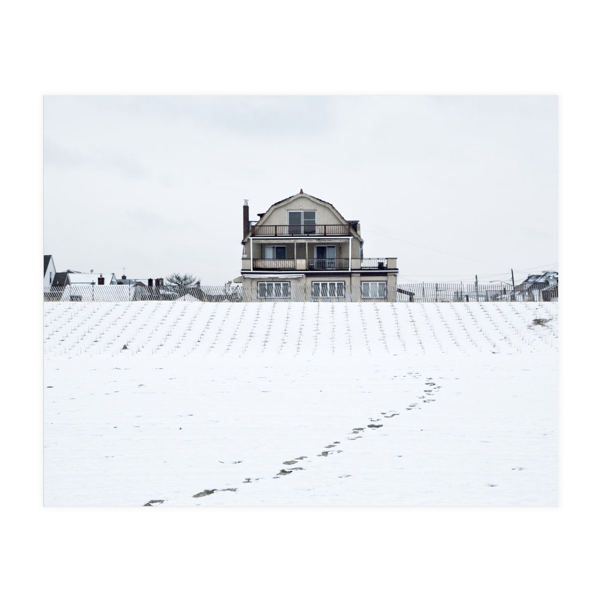 Footprints and house in winter snowscape (Print Only)