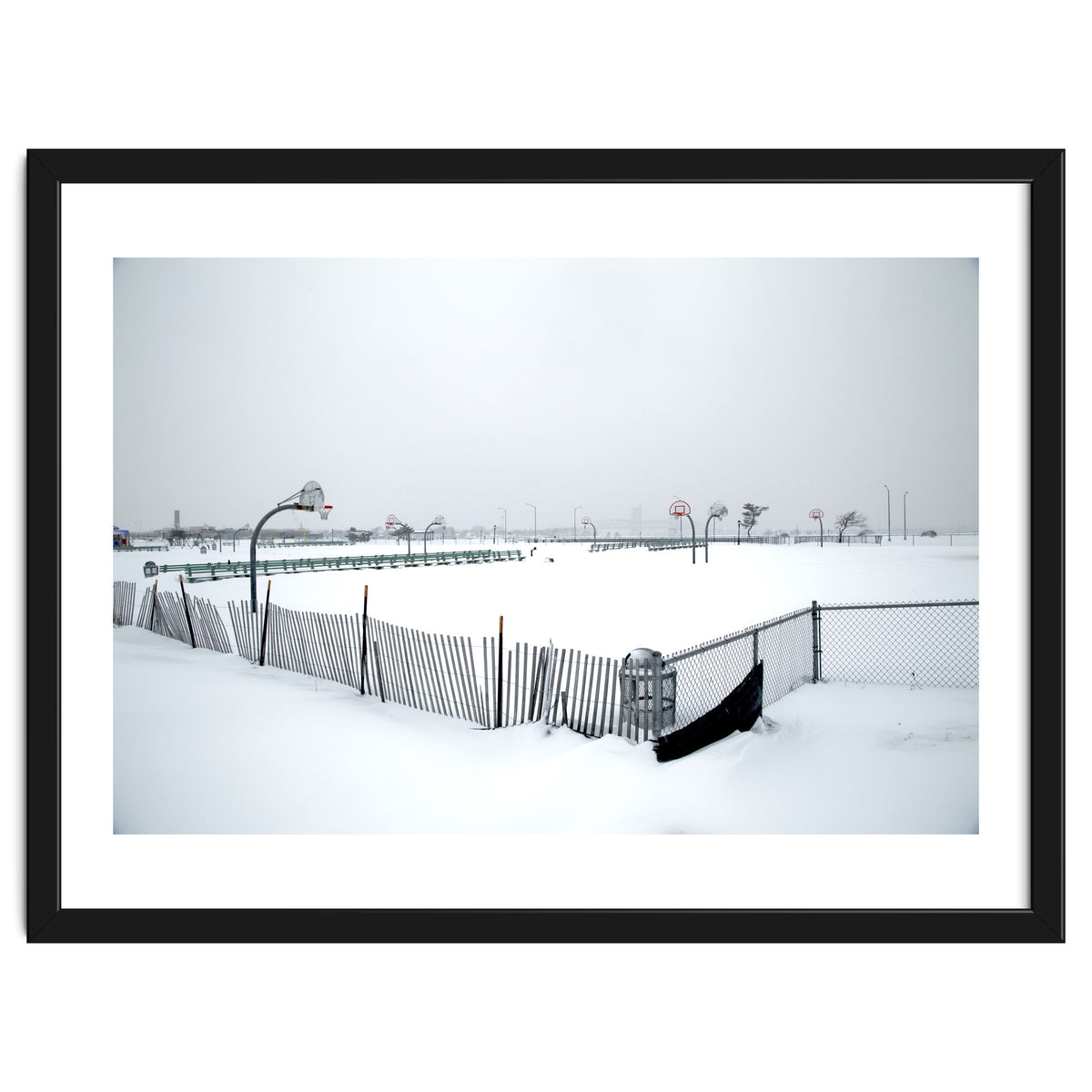 Snow-covered deserted basketball court in winter