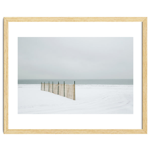 Wood fence in the winter snow beach