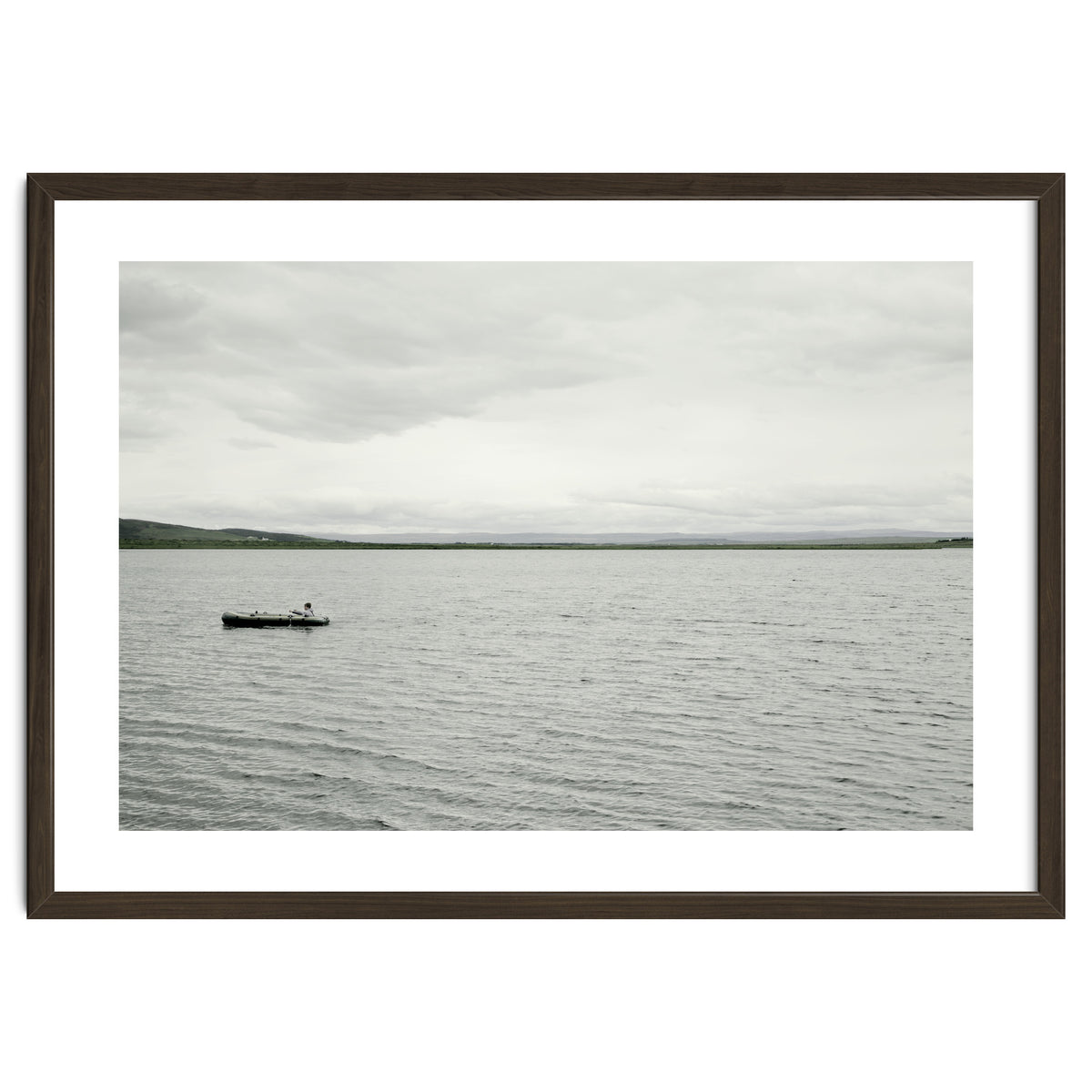 A boy pedaling the Board on the Lake - Iceland
