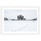 Footprints and house in winter snowscape thumbnail