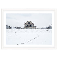 Footprints and house in winter snowscape