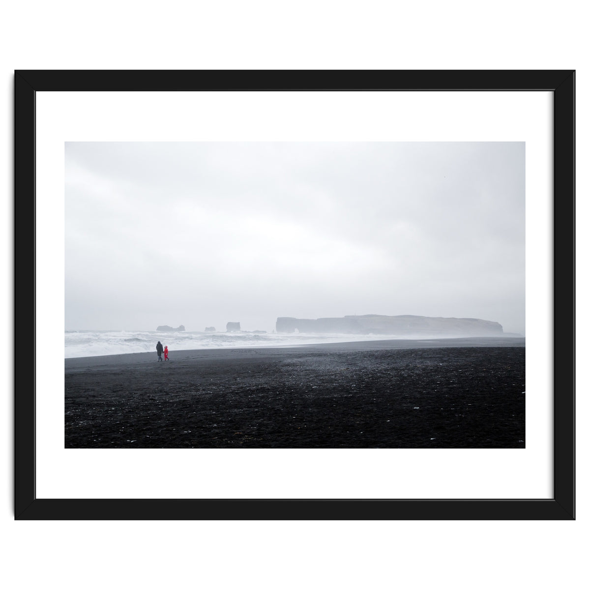 Family walking on the black sand beach - Iceland