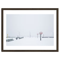 Snow-covered Basketball court and side bench