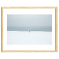 A walking woman in the winter snow beach