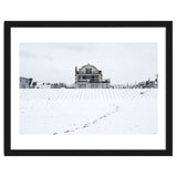 Footprints and house in winter snowscape thumbnail