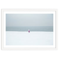 A walking woman in the winter snow beach