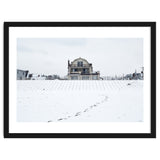 Footprints and house in winter snowscape thumbnail