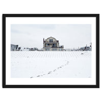 Footprints and house in winter snowscape