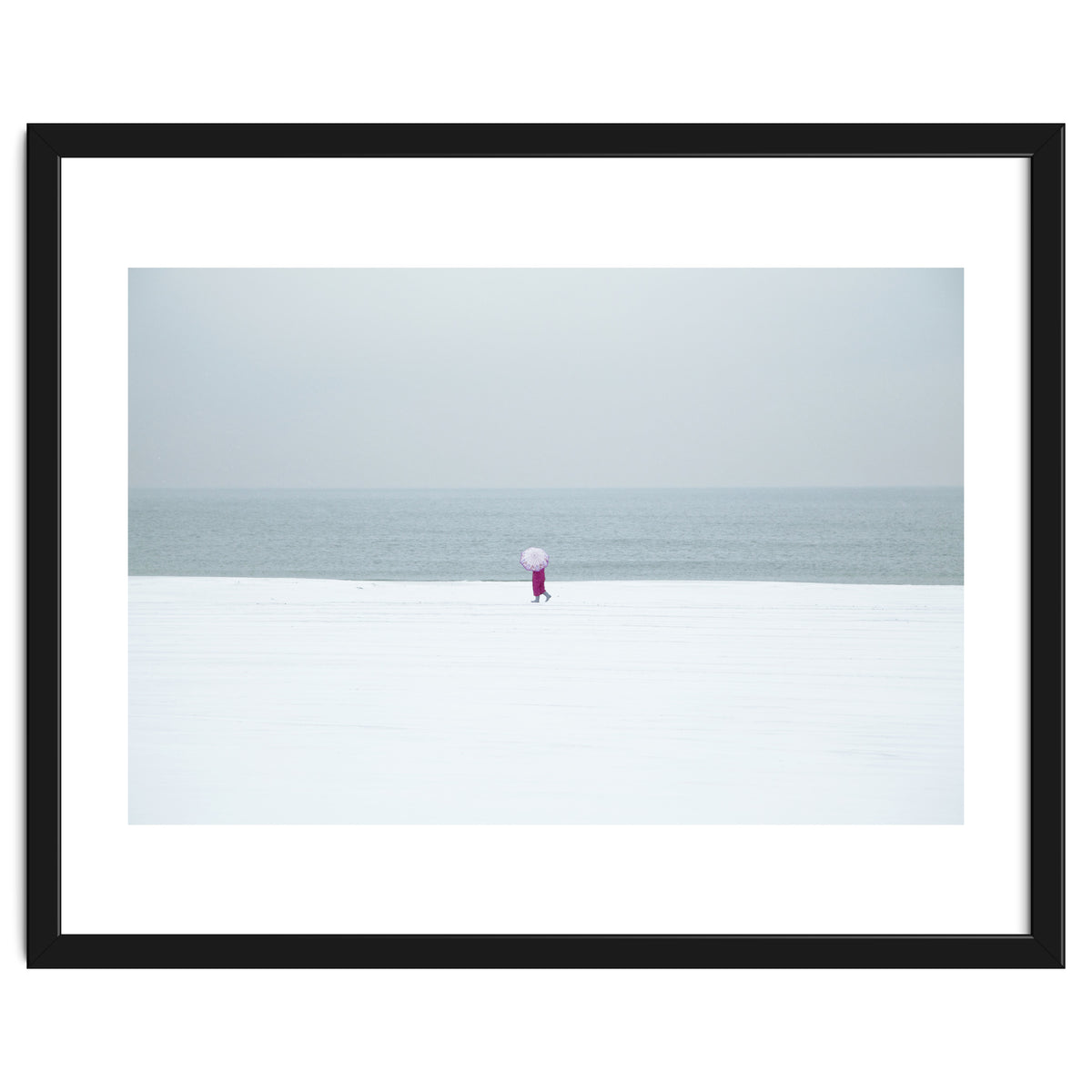 A walking woman in the winter snow beach