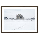 Footprints and house in winter snowscape thumbnail