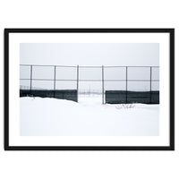 The entrance gate of the snow-covered baseball field