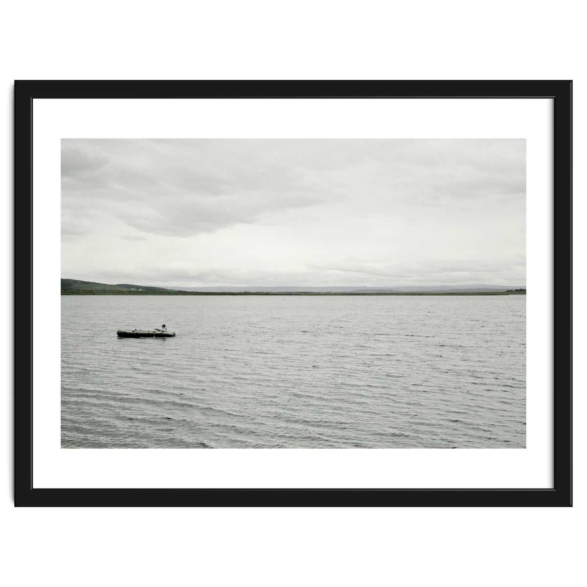A boy pedaling the Board on the Lake - Iceland