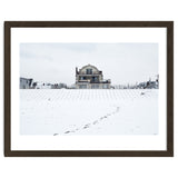 Footprints and house in winter snowscape thumbnail