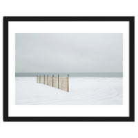 Wood fence in the winter snow beach