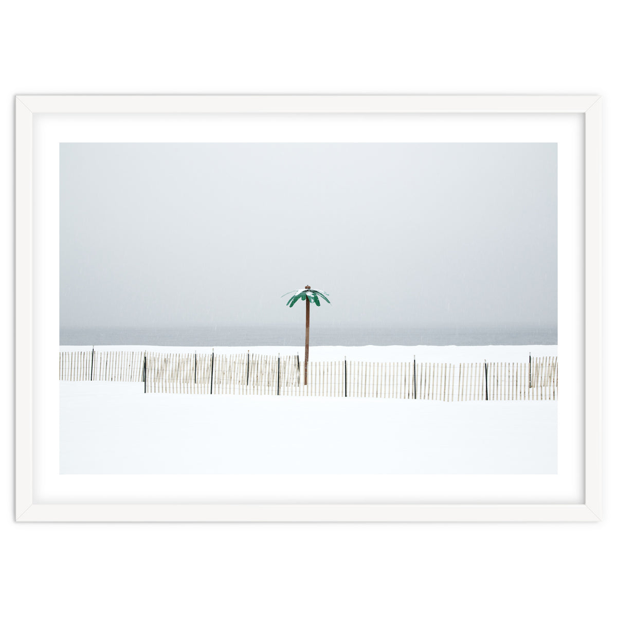 Fake palm tree in the winter snow beach