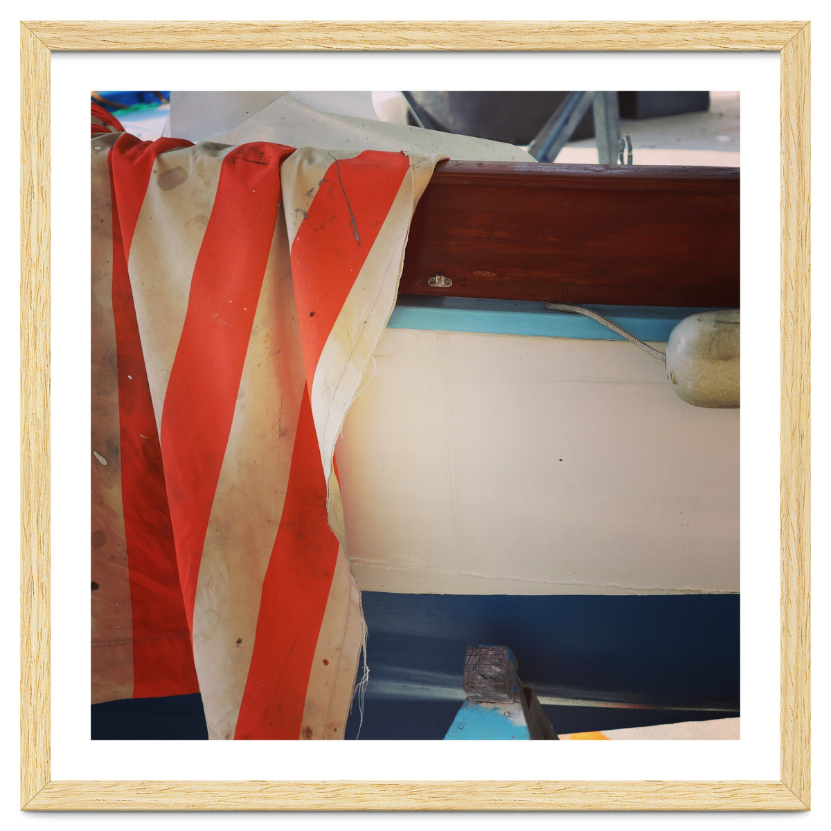 Fishing boat and striped sail