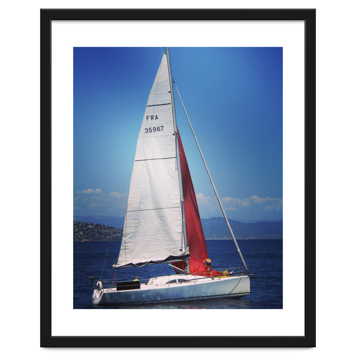 Sailing yacht with white and red sails