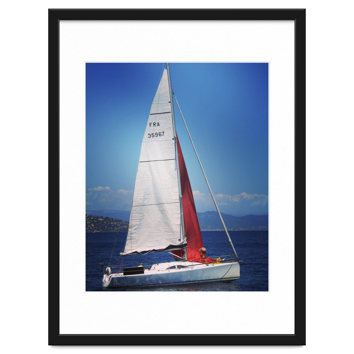 Sailing yacht with white and red sails