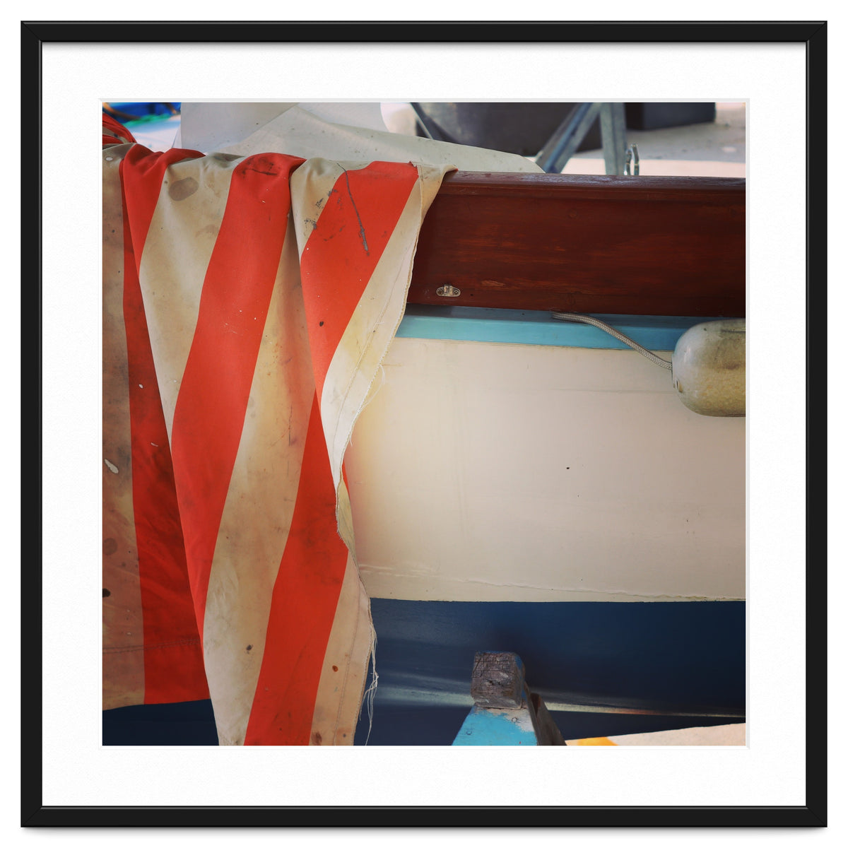 Fishing boat and striped sail