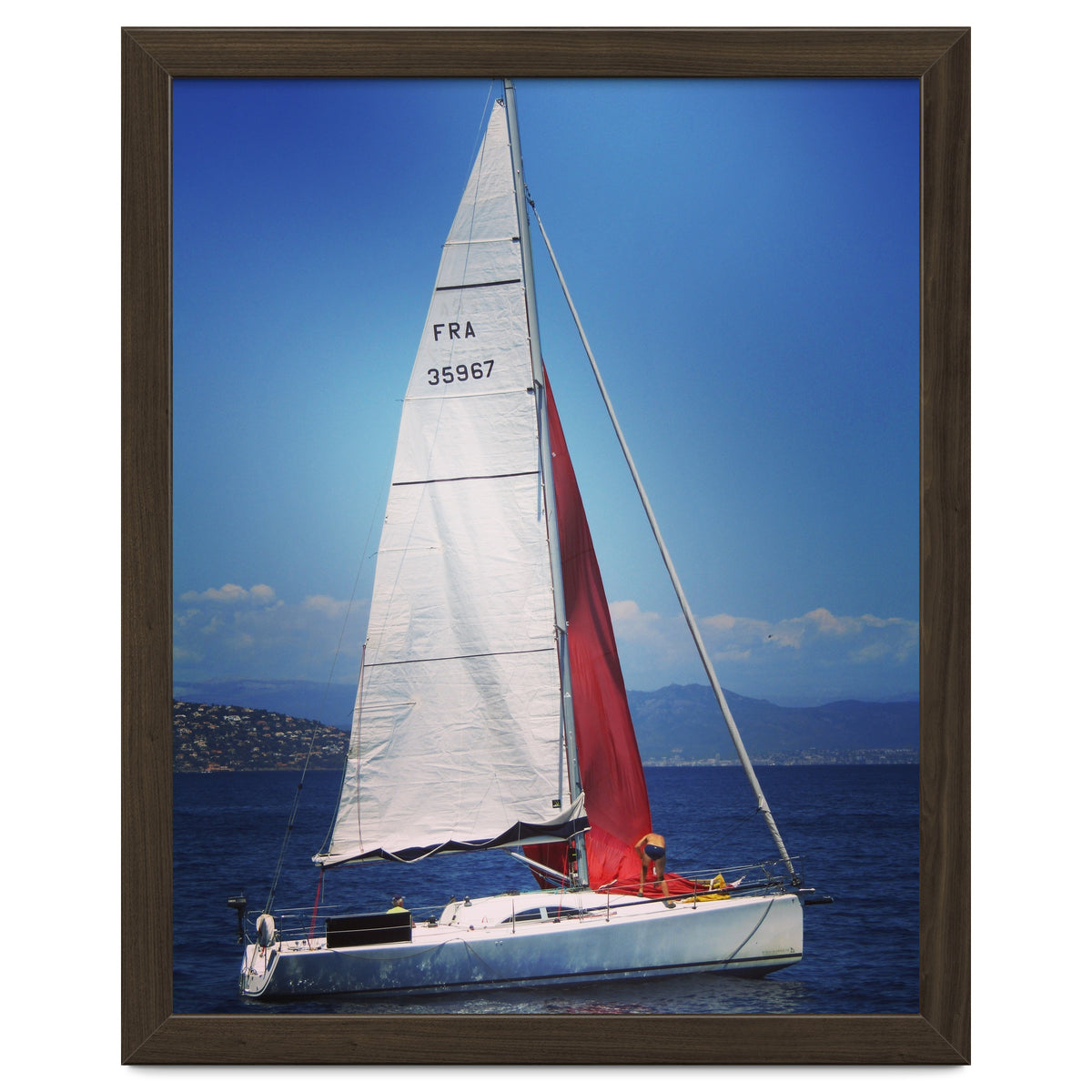 Sailing yacht with white and red sails