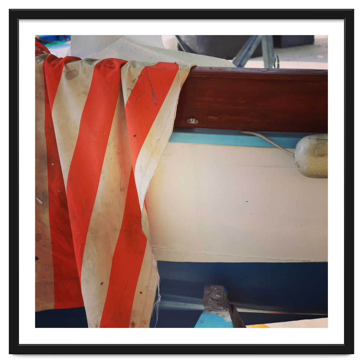 Fishing boat and striped sail