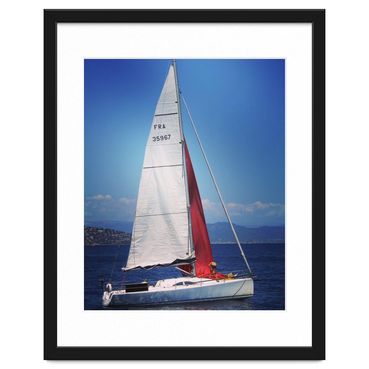 Sailing yacht with white and red sails