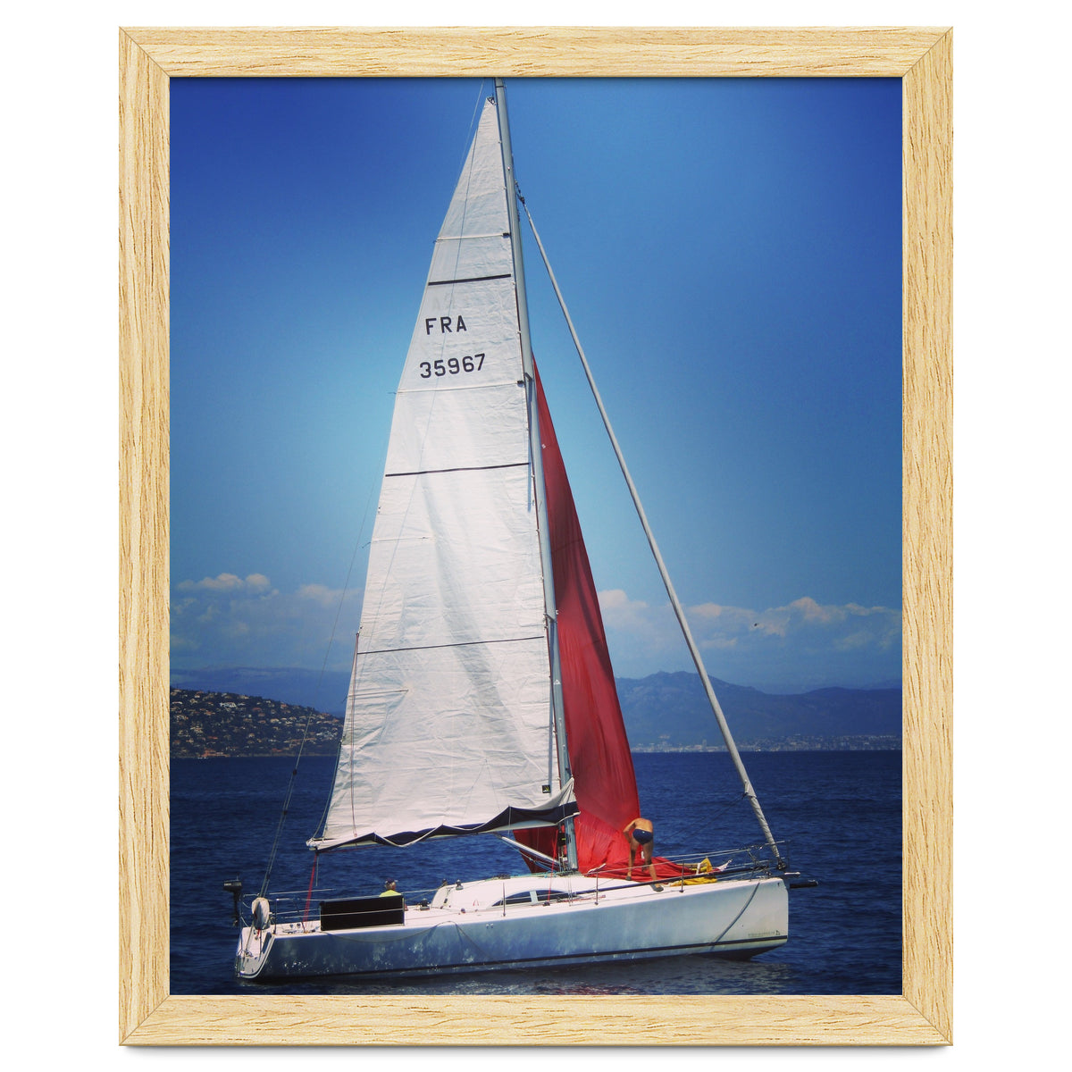 Sailing yacht with white and red sails